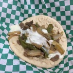 Cheesesteak Gripper - Philly cheesesteak on flatbread with grilled onion & peppers in creamy cheese sauce